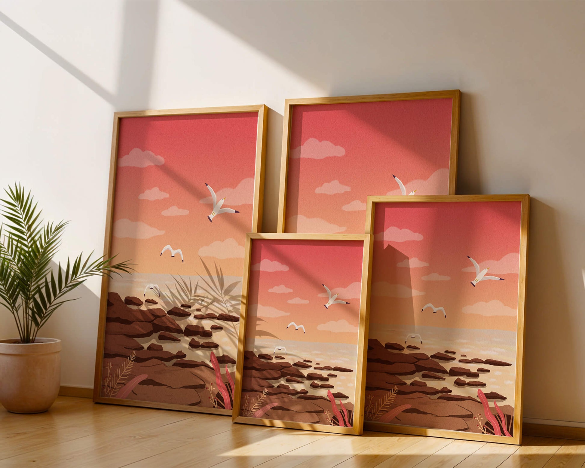 Seagulls flying over rocky coastline at sunset