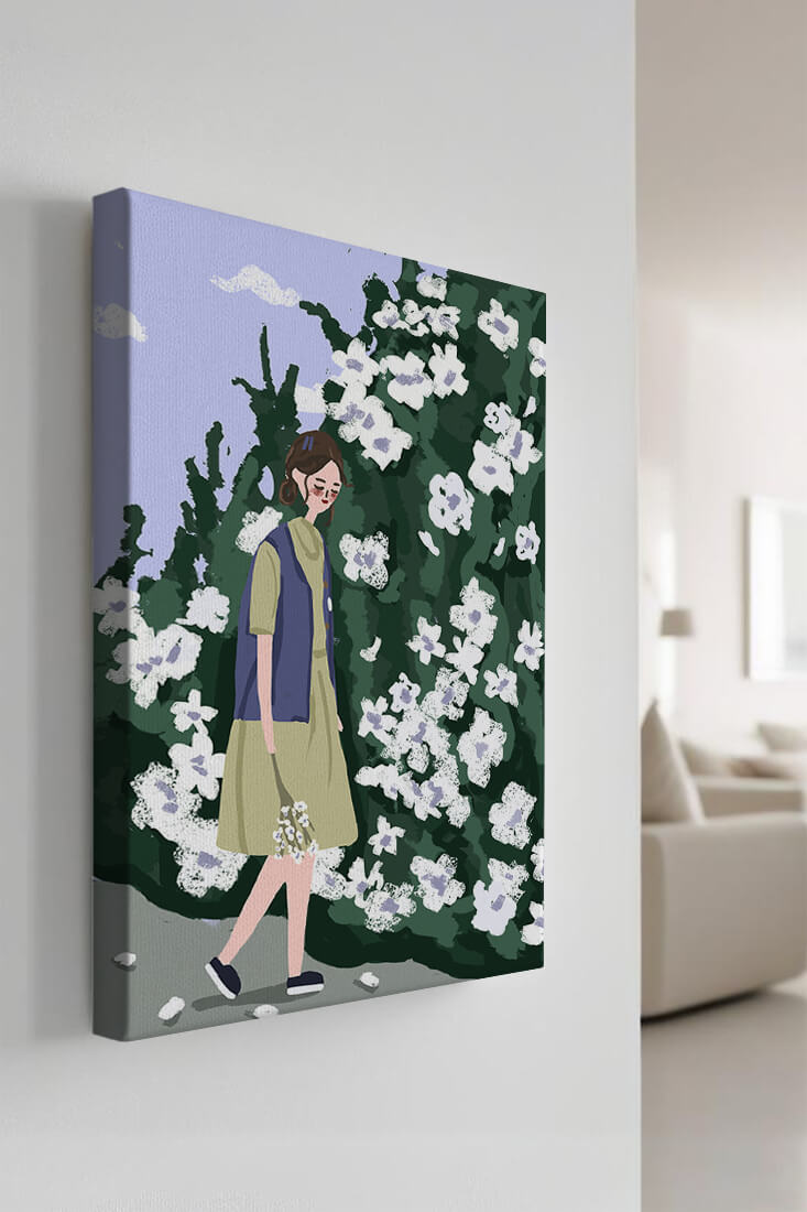 Woman walking by a lush white flower bush on a sunny day