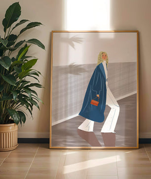 Fashionable Woman in Long Blue Coat Walking Along Corridor with Orange Handbag