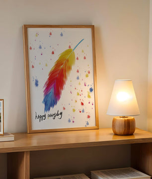 Colorful feather with inspirational message on abstract paint splatter background