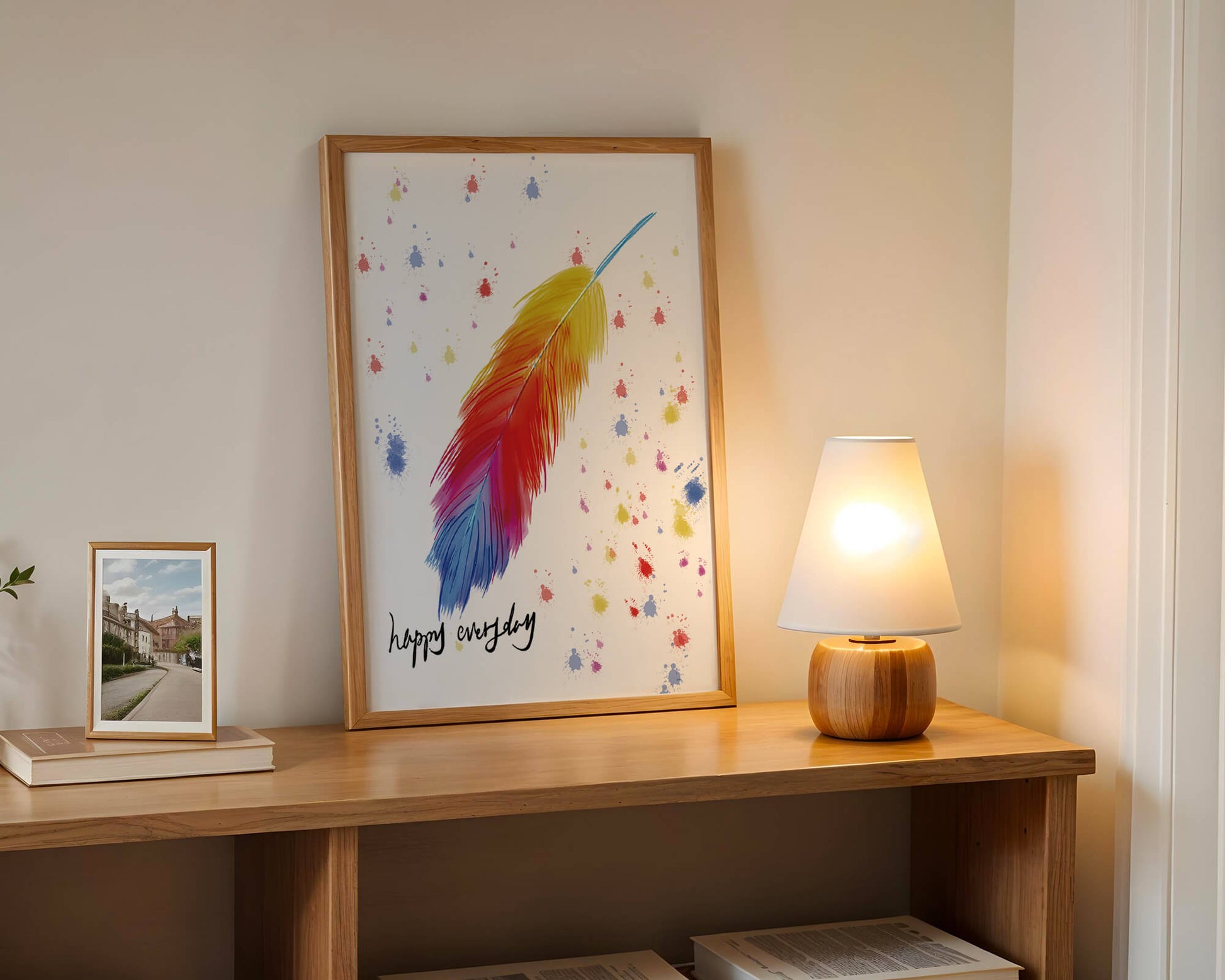 Colorful feather with inspirational message on abstract paint splatter background