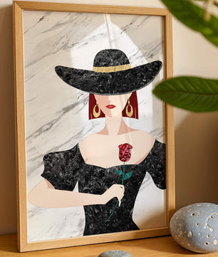 Elegant woman in wide-brimmed hat holding a rose on marble background