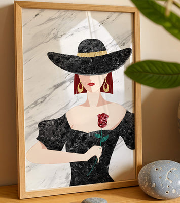 Elegant woman in wide-brimmed hat holding a rose on marble background