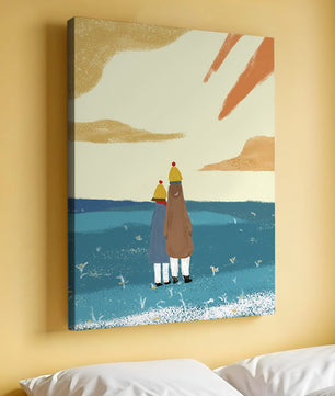 Two figures in winter clothing on a serene beach