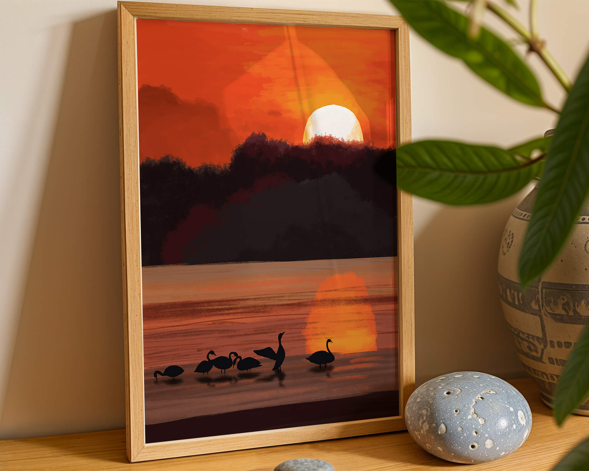 Serene sunset over a lake with silhouetted swans