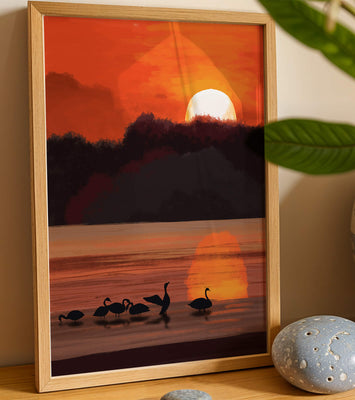 Serene sunset over a lake with silhouetted swans
