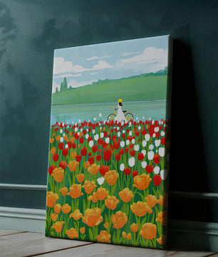 Woman with bicycle in vibrant tulip field by a lake
