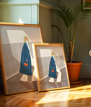 Fashionable Woman in Long Blue Coat Walking Along Corridor with Orange Handbag