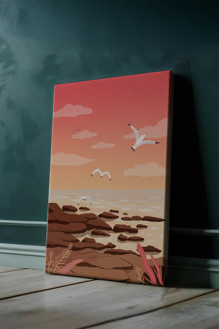Seagulls flying over rocky coastline at sunset