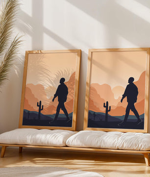 Silhouetted figure walking in desert landscape at sunset