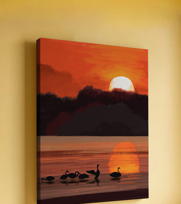 Serene sunset over a lake with silhouetted swans