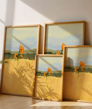 Orange Flowers in a Golden Field with Mountains and Blue Sky
