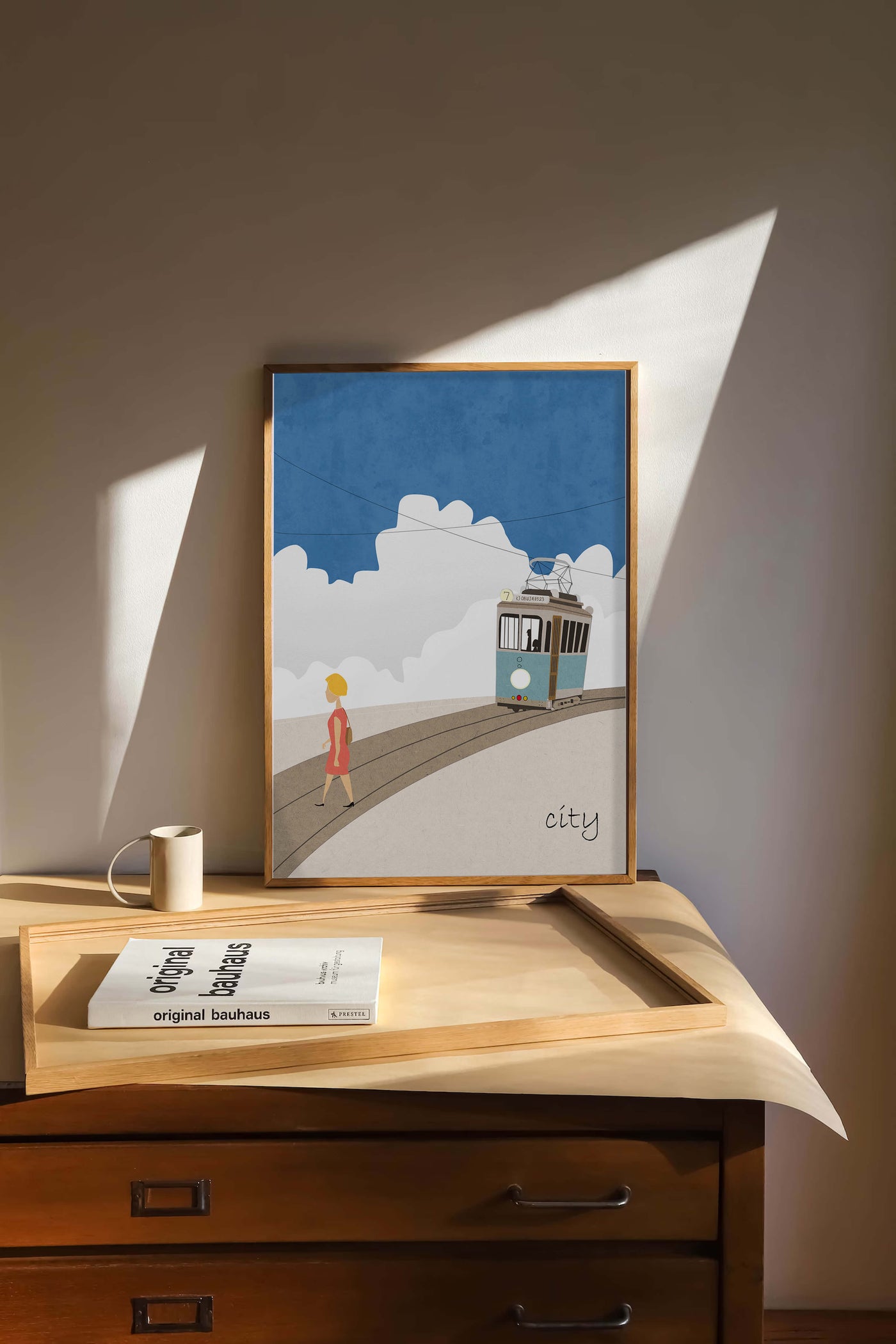 Urban scene with tram and pedestrian under a blue sky