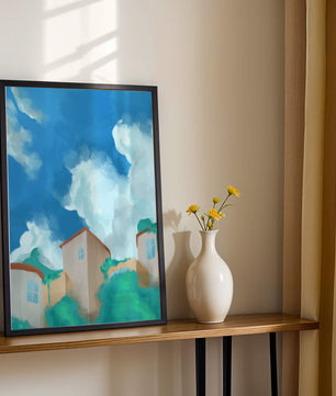 Serene landscape with houses and fluffy clouds against a blue sky