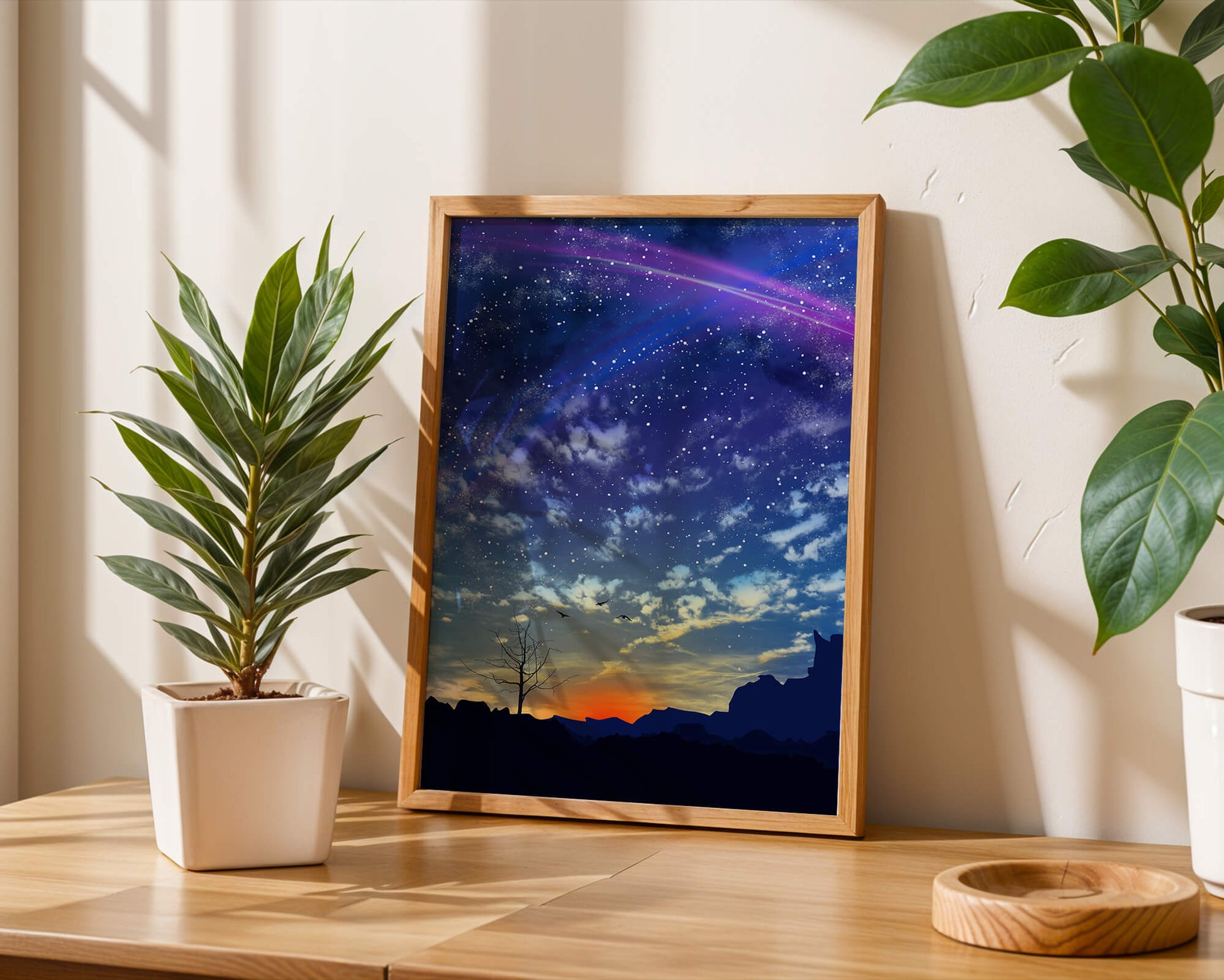 Starlit night sky with colorful sunset and silhouetted landscape