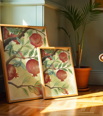 Watercolor illustration of pomegranates on a branch with leaves