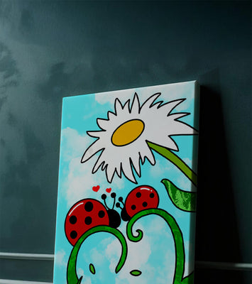 Ladybugs in love beneath a daisy on a bright sky