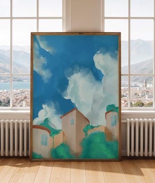 Serene landscape with houses and fluffy clouds against a blue sky