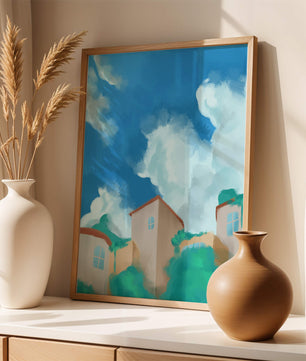 Serene landscape with houses and fluffy clouds against a blue sky