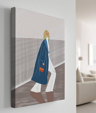 Fashionable Woman in Long Blue Coat Walking Along Corridor with Orange Handbag