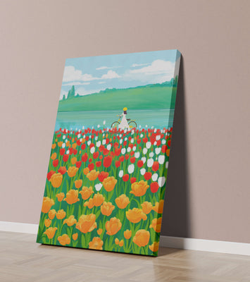 Woman with bicycle in vibrant tulip field by a lake