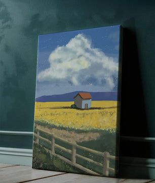 Idyllic rural scene with house and yellow field under blue sky