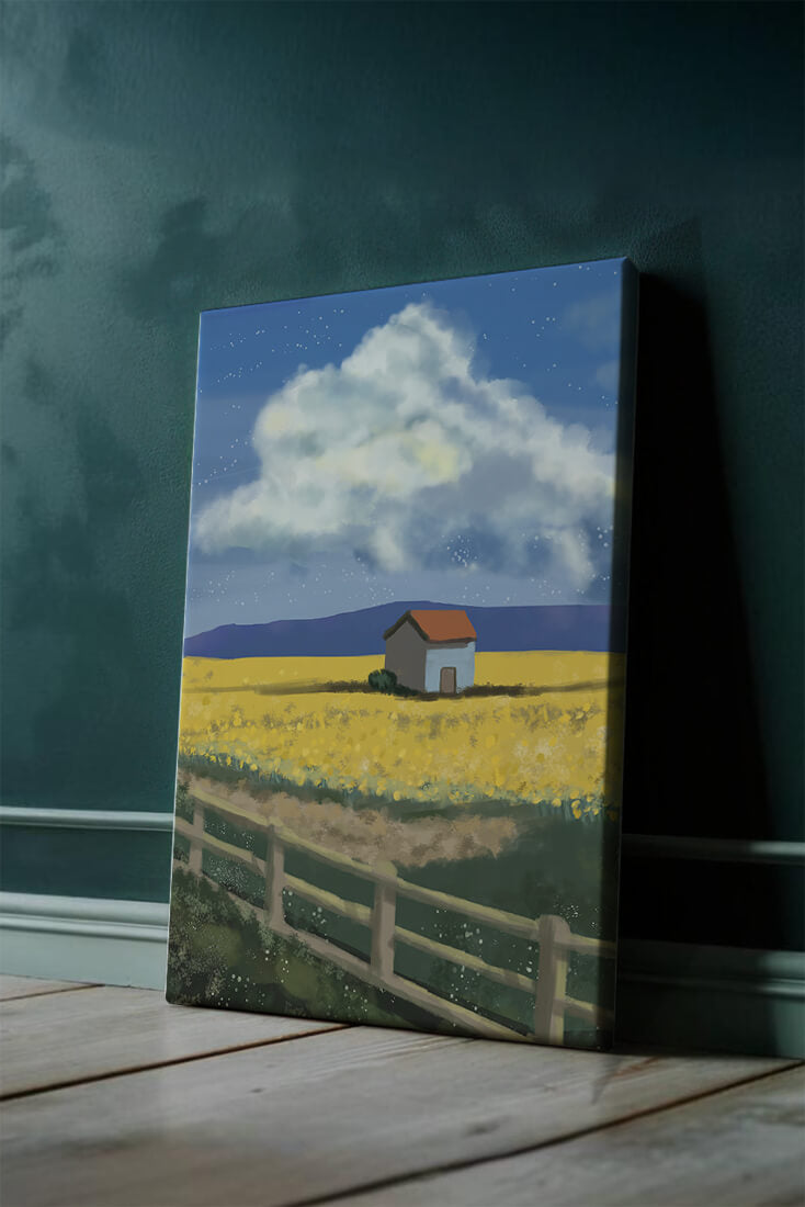 Idyllic rural scene with house and yellow field under blue sky