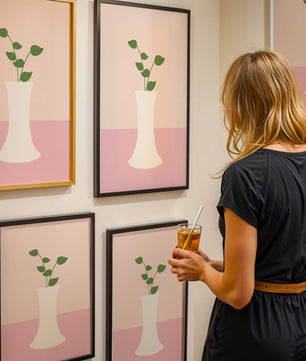 Simple Minimalist Illustration of a White Vase with Green Leaves on a Pink Background - Mi tienda