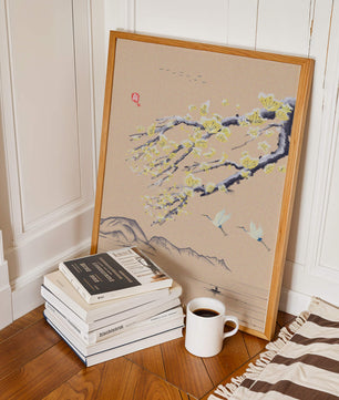 Tranquil landscape with blooming branches and flying cranes