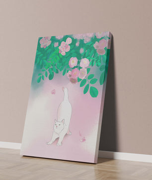White cat stretching beneath blooming flowers in a pastel garden setting
