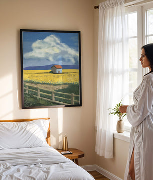 Idyllic rural scene with house and yellow field under blue sky