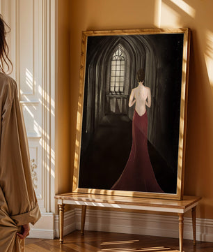 Elegant woman in a red dress inside a gothic hallway