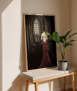 Elegant woman in a red dress inside a gothic hallway