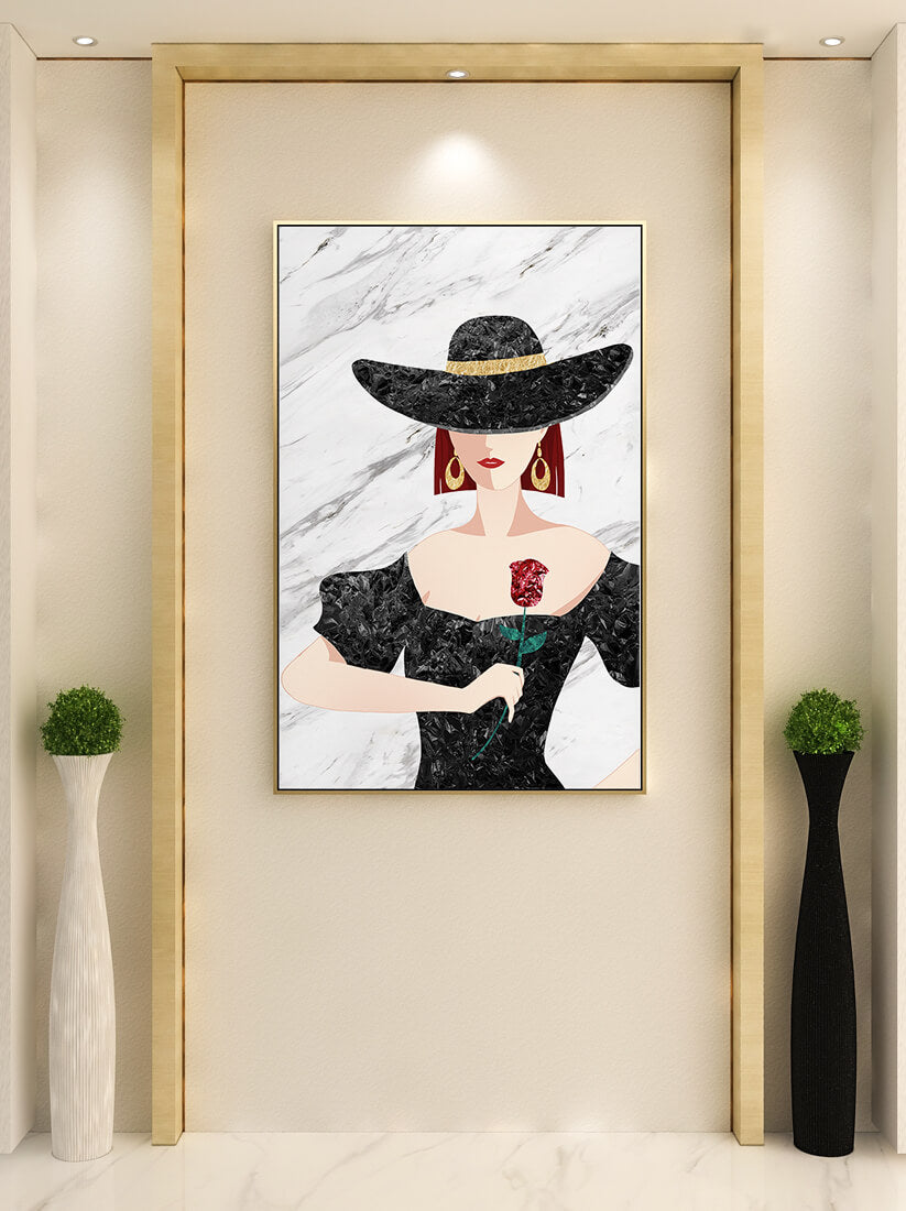 Elegant woman in wide-brimmed hat holding a rose on marble background