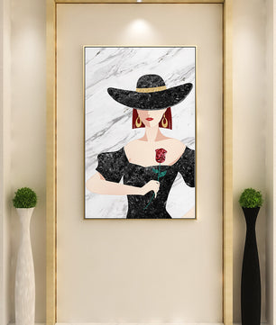 Elegant woman in wide-brimmed hat holding a rose on marble background