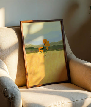 Orange Flowers in a Golden Field with Mountains and Blue Sky