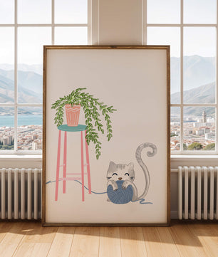 Cat Playing with Yarn Beside a Potted Plant on Pink Stool - Mi tienda