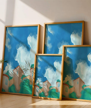 Serene landscape with houses and fluffy clouds against a blue sky