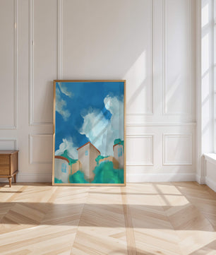 Serene landscape with houses and fluffy clouds against a blue sky