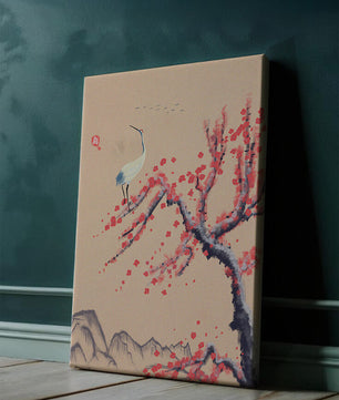 Elegant crane on cherry blossom tree with mountainous background