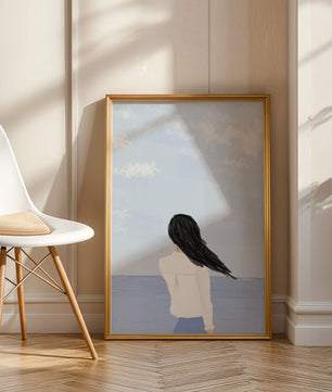 Woman gazing at the ocean with blue sky and clouds