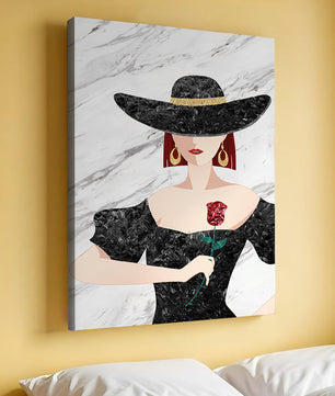 Elegant woman in wide-brimmed hat holding a rose on marble background