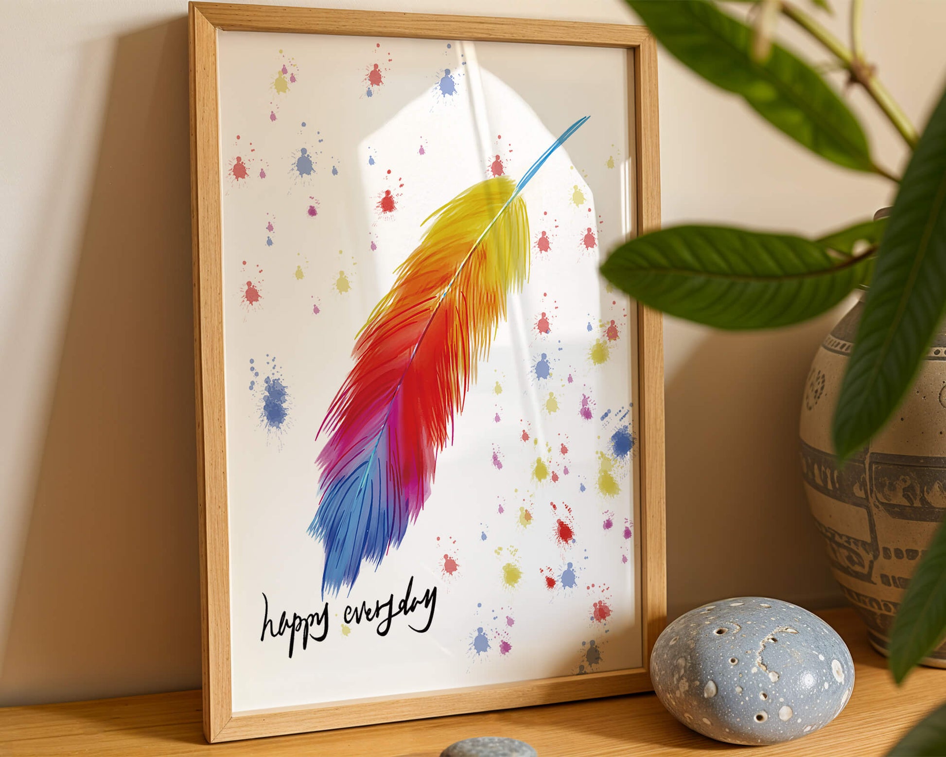 Colorful feather with inspirational message on abstract paint splatter background