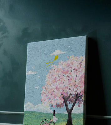 Springtime scene with cherry blossom and girl with bicycle