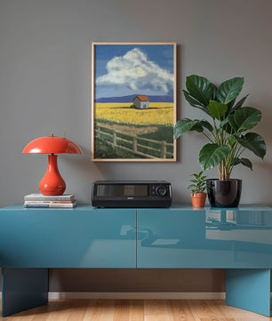 Idyllic rural scene with house and yellow field under blue sky