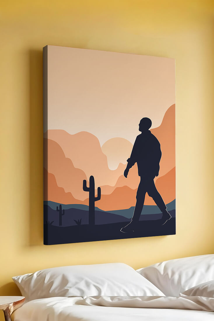 Silhouetted figure walking in desert landscape at sunset