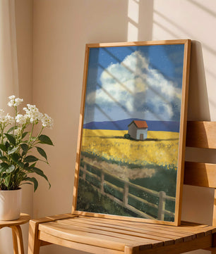 Idyllic rural scene with house and yellow field under blue sky