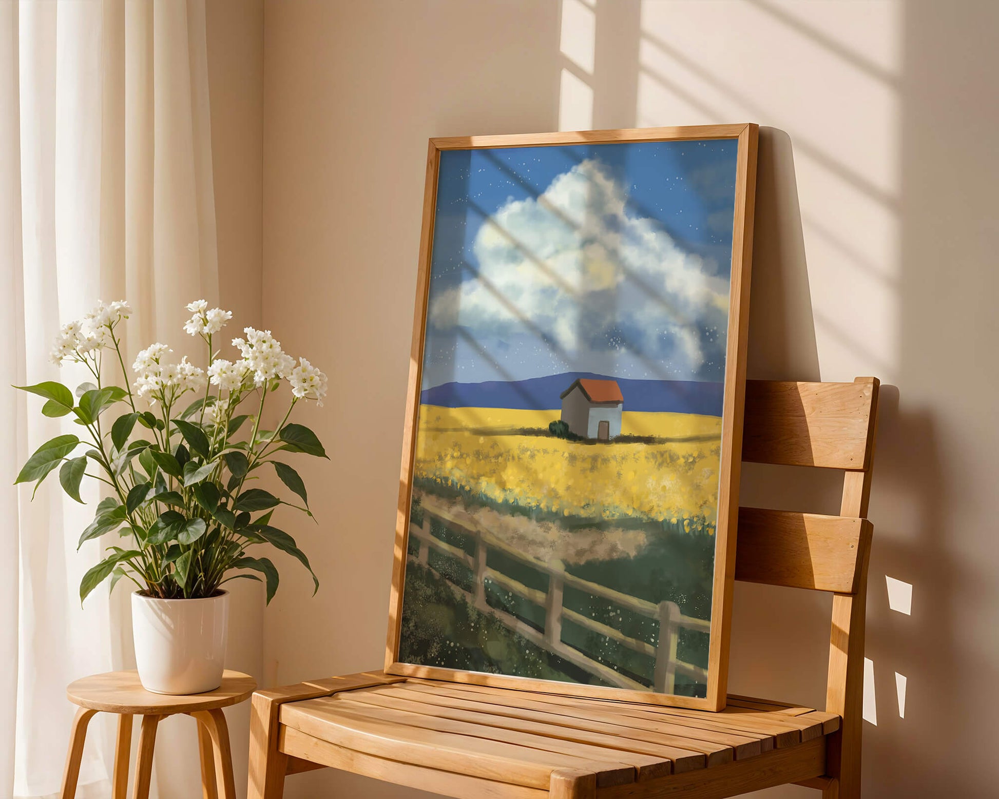 Idyllic rural scene with house and yellow field under blue sky