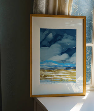 Dynamic Ocean Waves Under Cloudy Sky With Seagulls And Gold-Tinted Sand