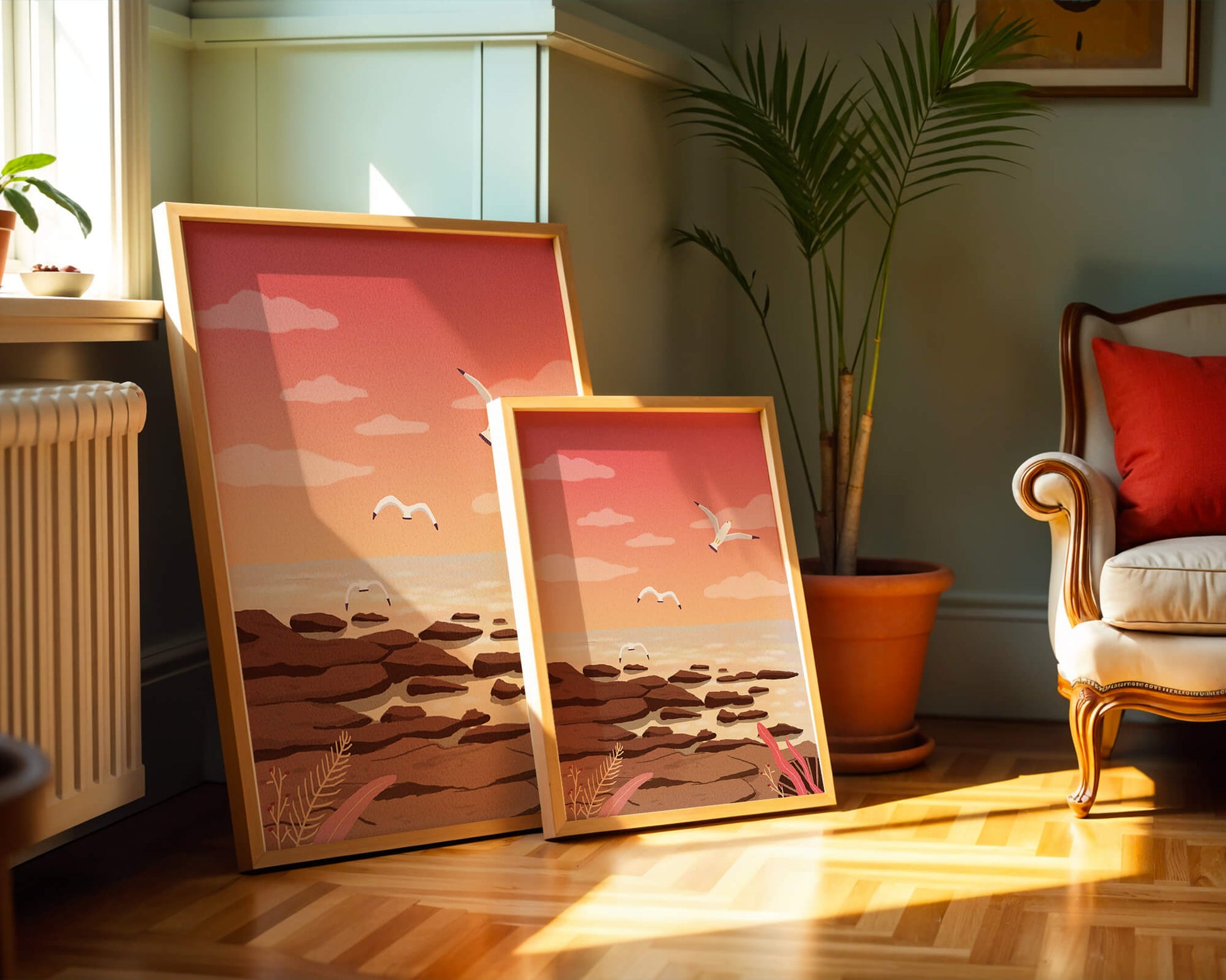Seagulls flying over rocky coastline at sunset